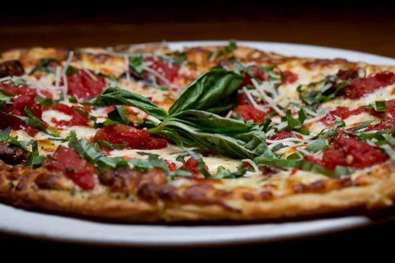 Margarita pizza with fresh basil at Tomatoes Italian Grille